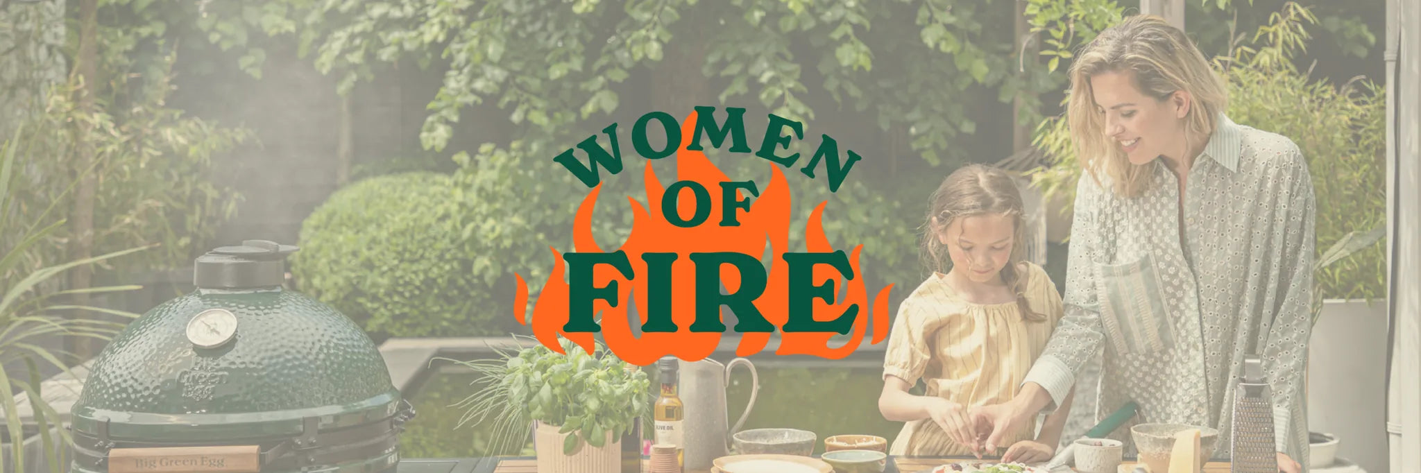 Two women and a child by a grill with 'Women of Fire' logo.