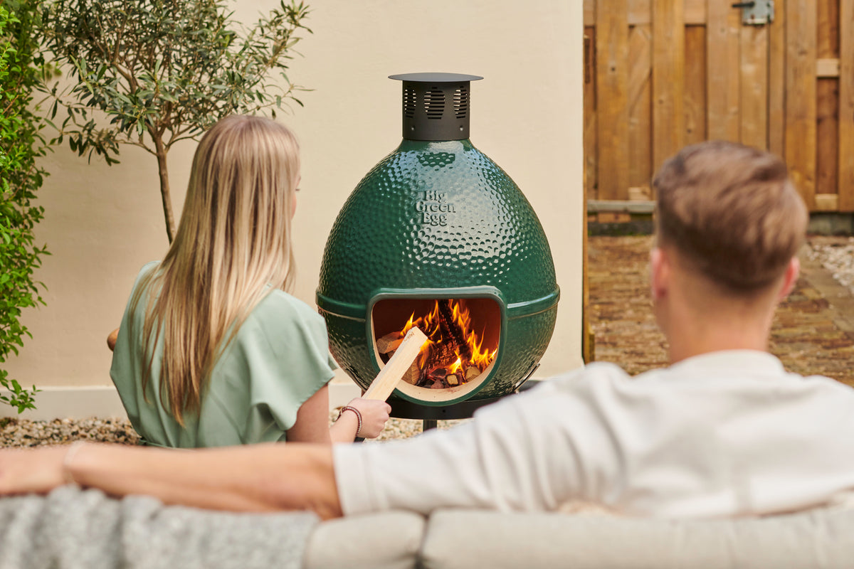 Couple Relaxing next to a Chiminea fire