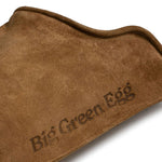 Close-up of the Hell Hands glove cuff in tan suede with the Big Green Egg logo embossed