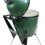 Green ceramic kamado grill with stand on a white background
