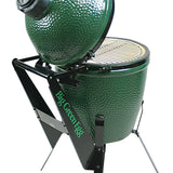 Green ceramic kamado grill with stand on a white background