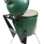 Green ceramic kamado grill with stand on a white background