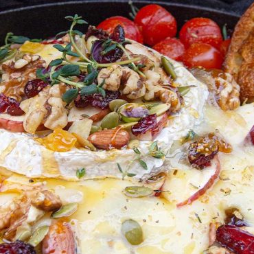 Holiday Baked Brie with Herbs, Berries, Nuts and Honey.